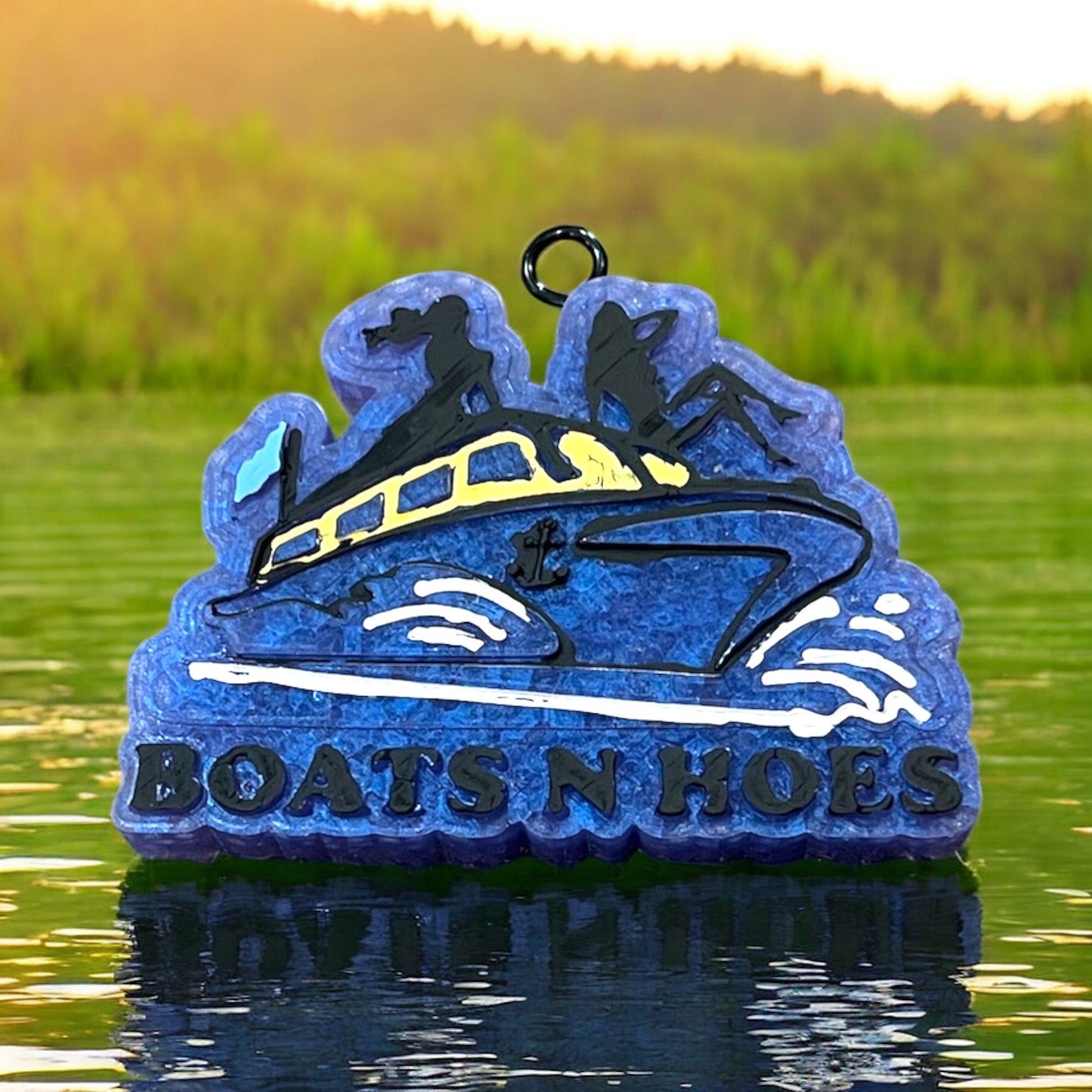 Decorative scented aroma decor with a boat and 'BOATS N HOES' text on a water background