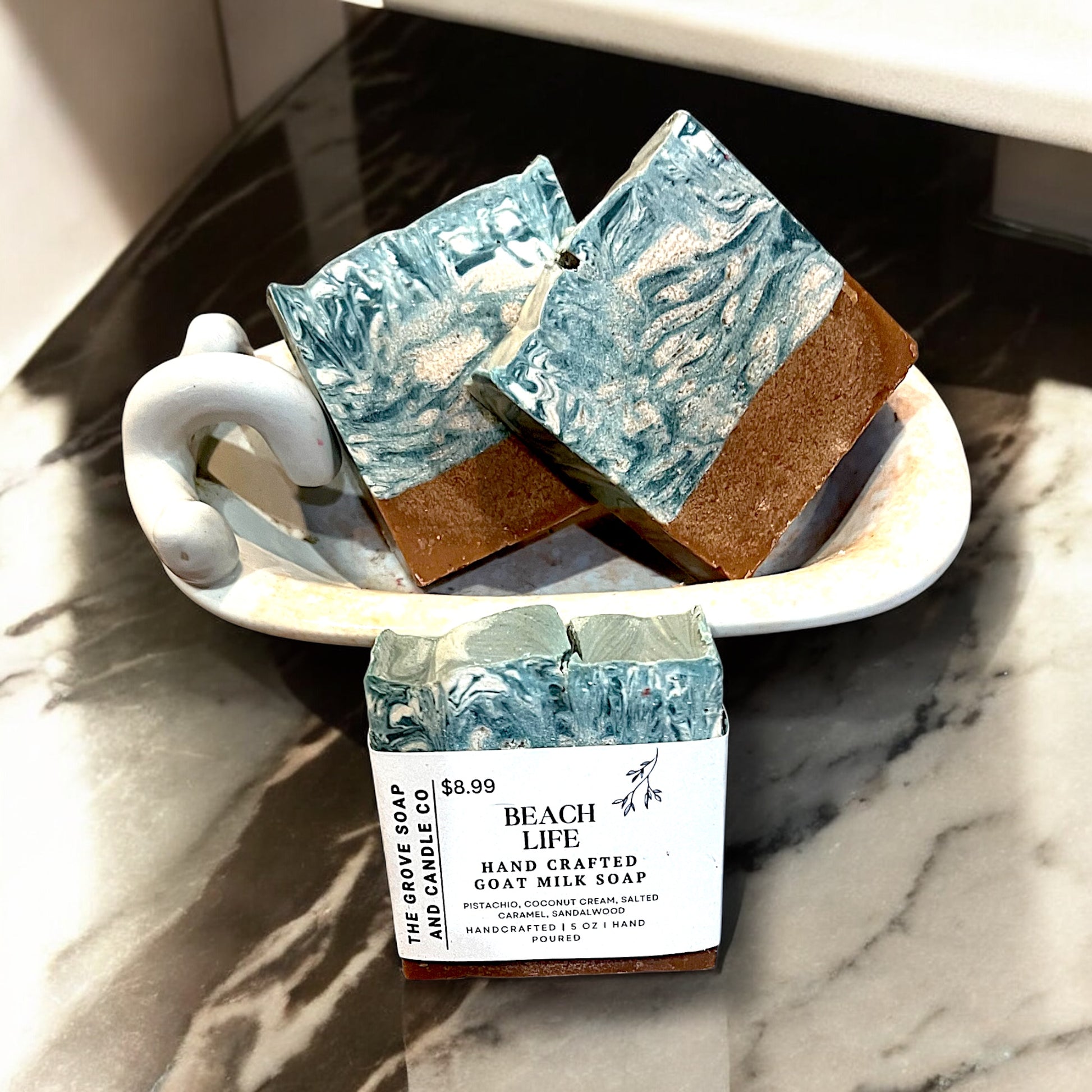 Hand-poured luxury bath soap Beach Life depicting the scents of pistachio and coconut cream in a bath tub.