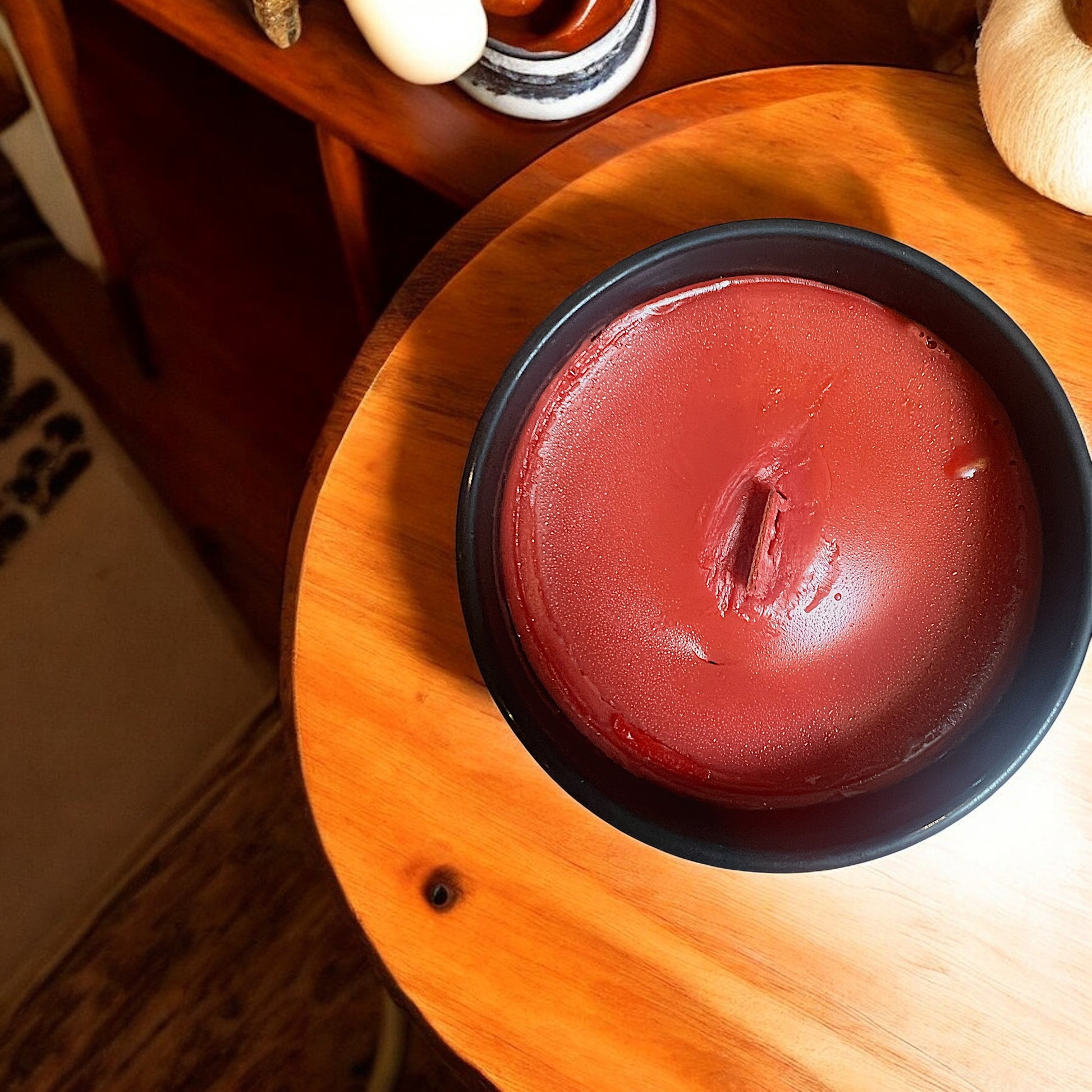 A deep red colored wax blend color showcasing a western rustic candle. The wooden wick ensures optimal aroma release.