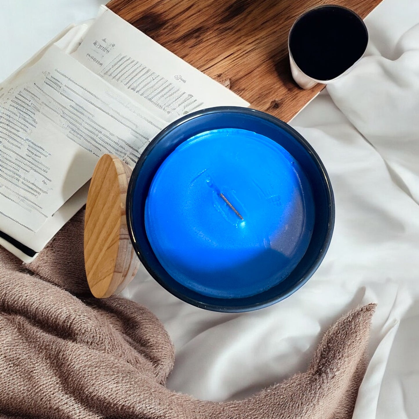 Wooden wick candle with warm ambiance and rustic aesthetic. Denim blue wax.