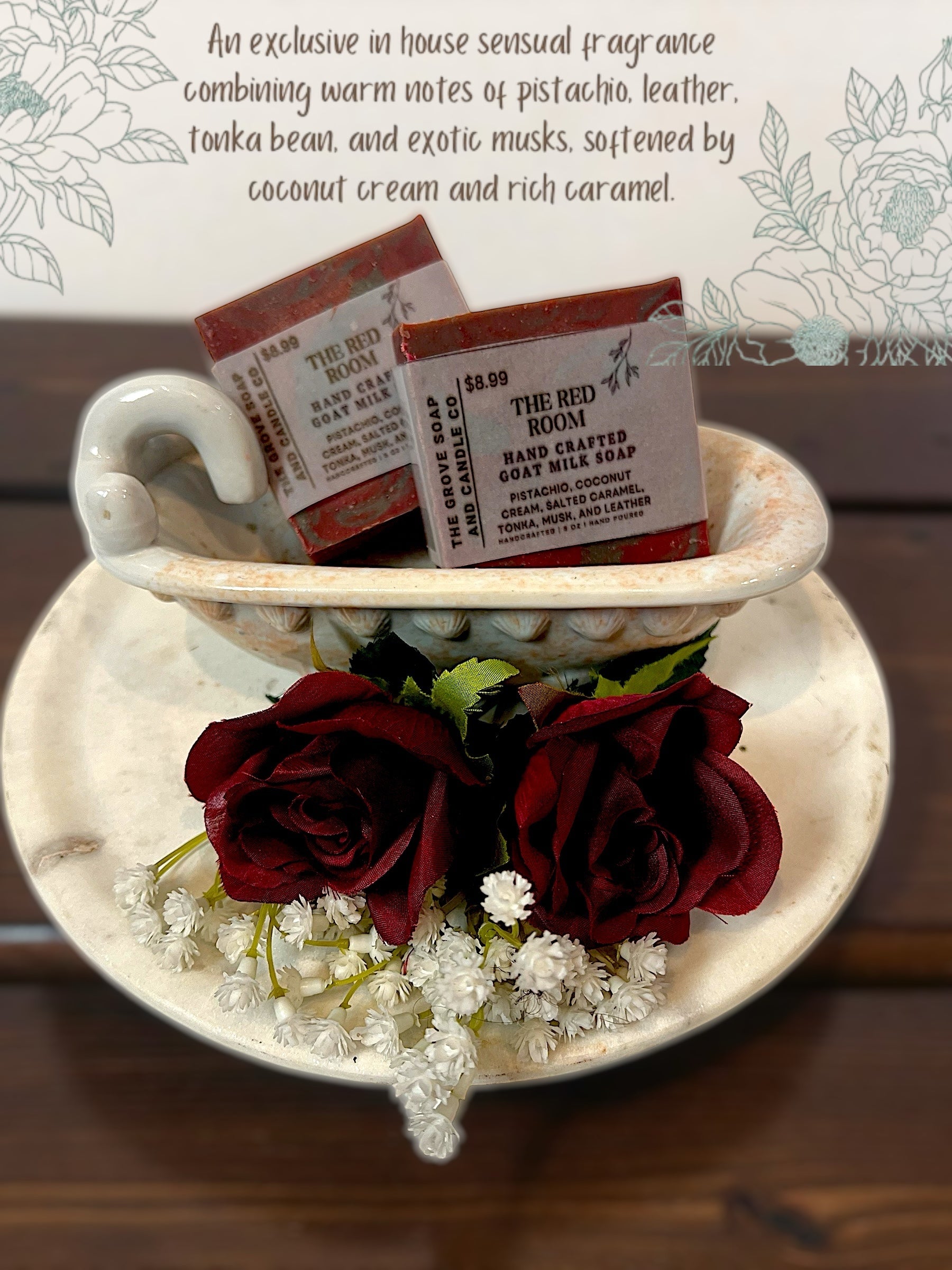 Two soap bars in a porcelain tub with red roses and white flowers on a wooden surface describing the scent of the soap