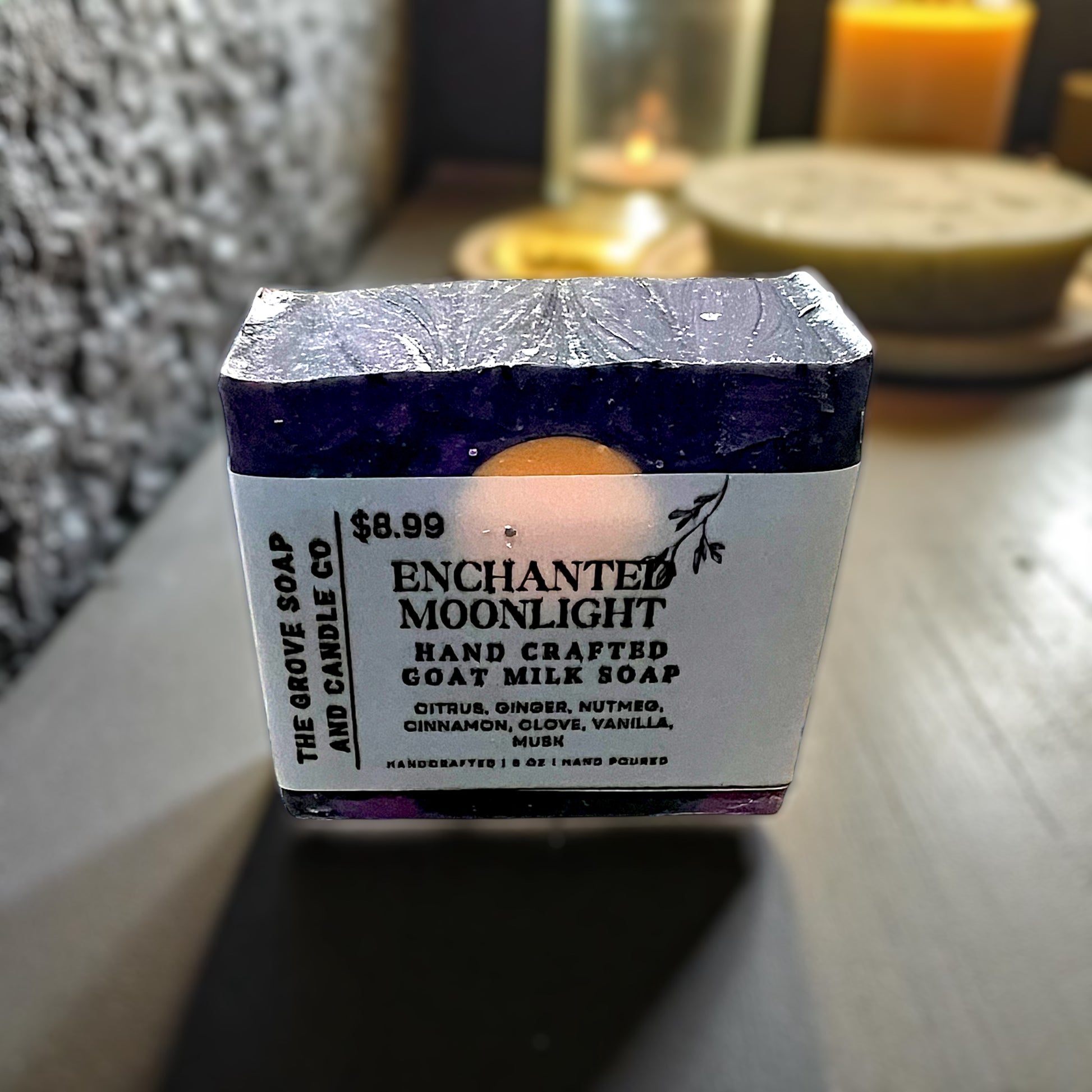 Close up of Enchanted Moonlight goat milk soap from The Grove Soap and Candle Co on a wooden surface.