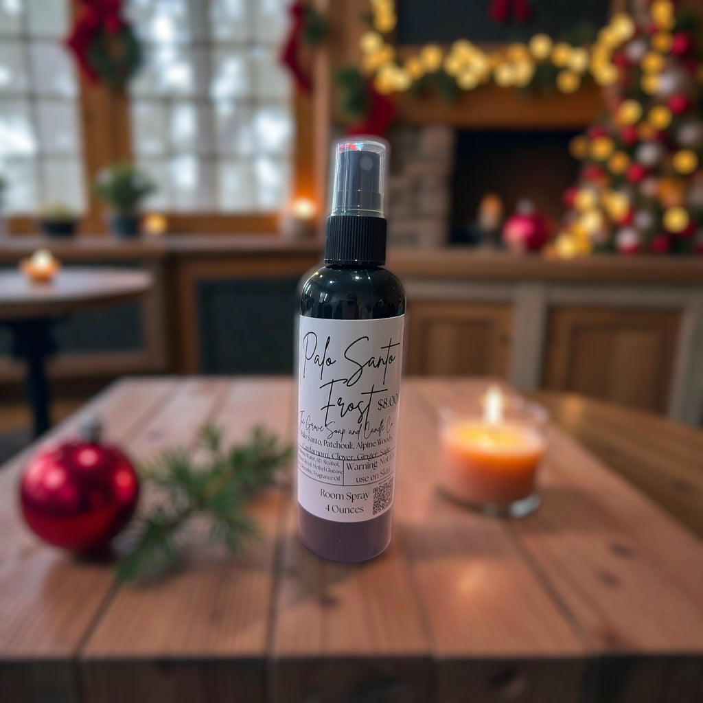 Palo Santo Frost spray bottle on a wooden table with festive decorations in the background
