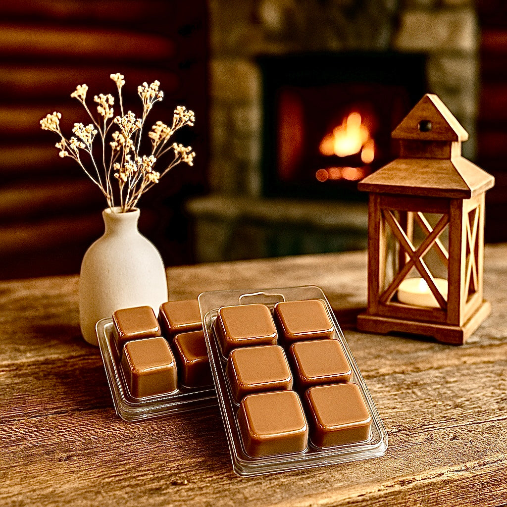 Wax melts in packaging on a wooden surface with a lantern and vase in the background. Saddle shop leather colored. 