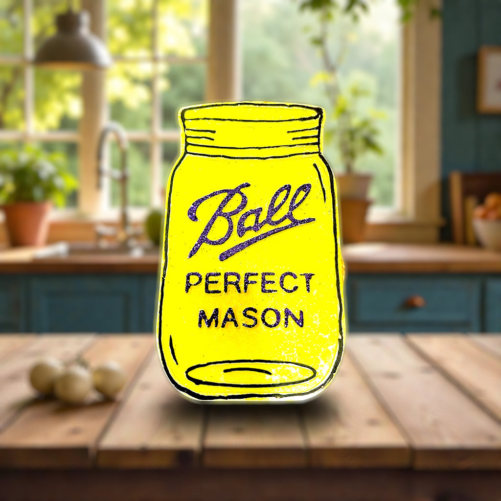 Yellow 'Ball Perfect Mason' jar illustration on a wooden table with a kitchen background
