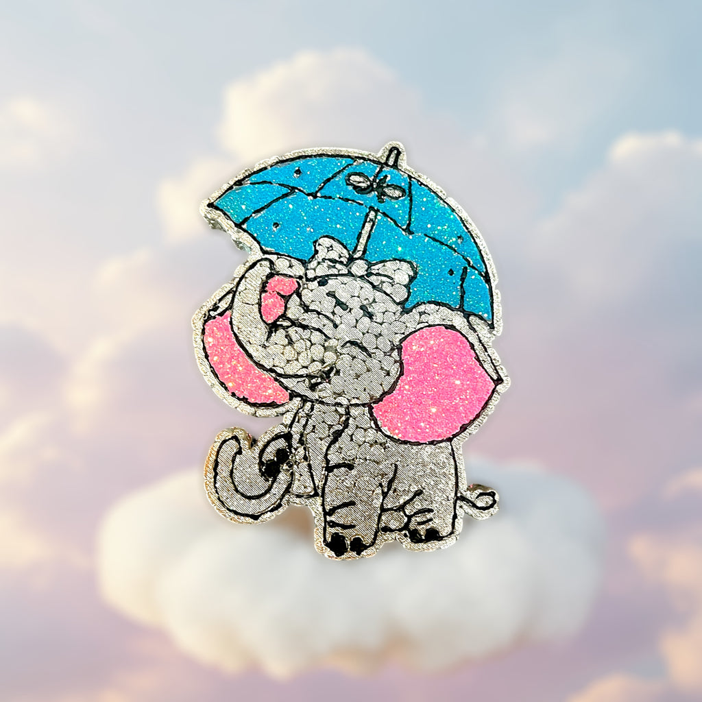 Grey elephant car freshie with pink glitter ears and blue glittered umbrella