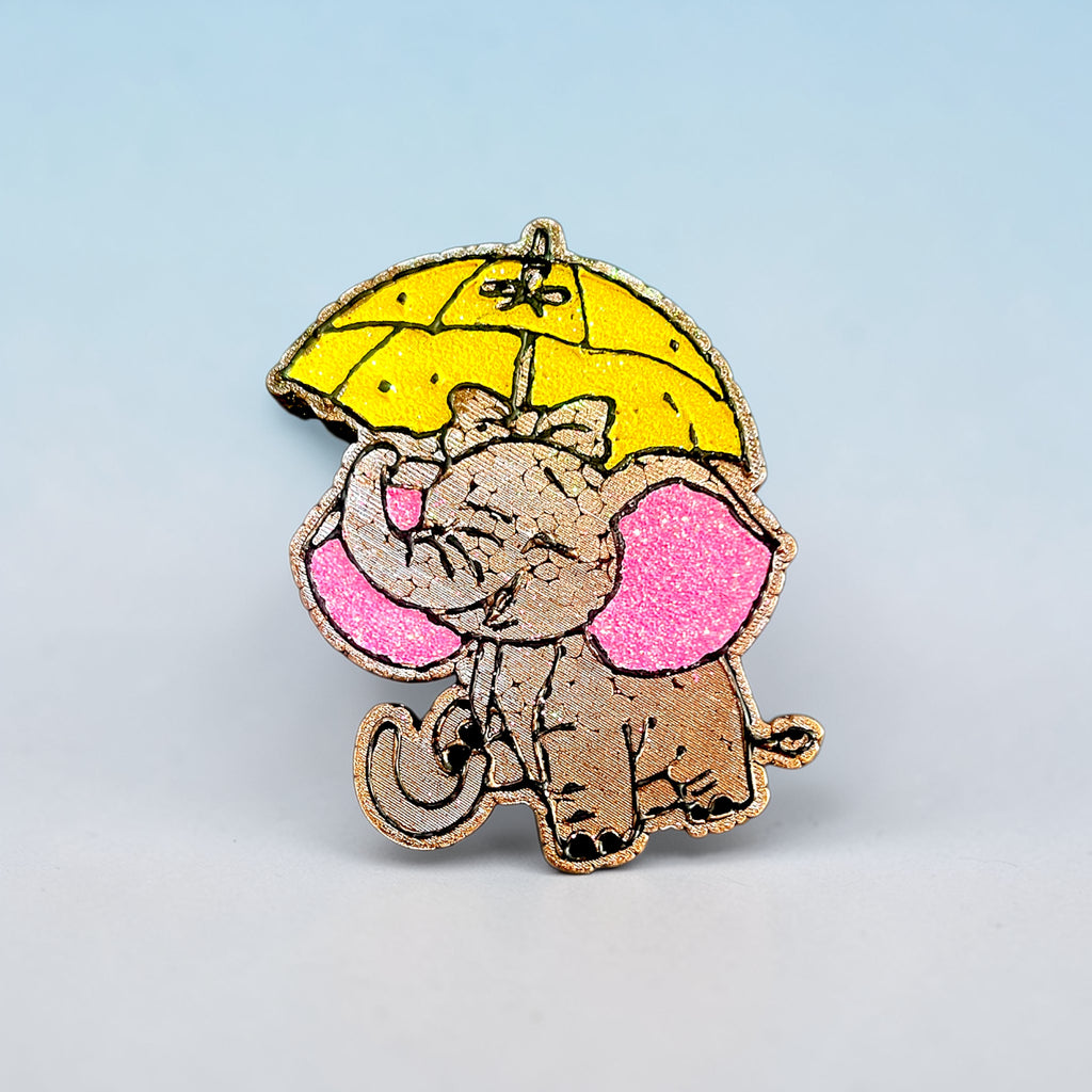 Brown elephant car freshie with yellow glittered umbrella and pink glittered ears.