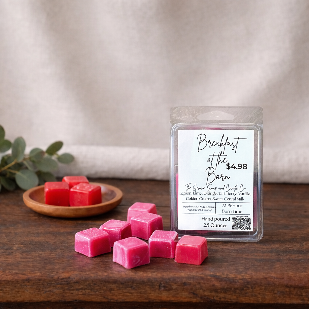 Breakfast at the Barn Wax Melts. Sitting on a wooden table with a linen background. Next to a wooden bowl filled with red wax melts. 