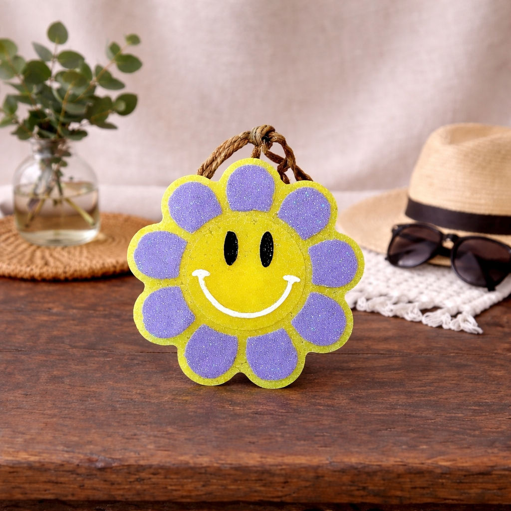Bright yellow smiley car freshie with purple glitter petals.