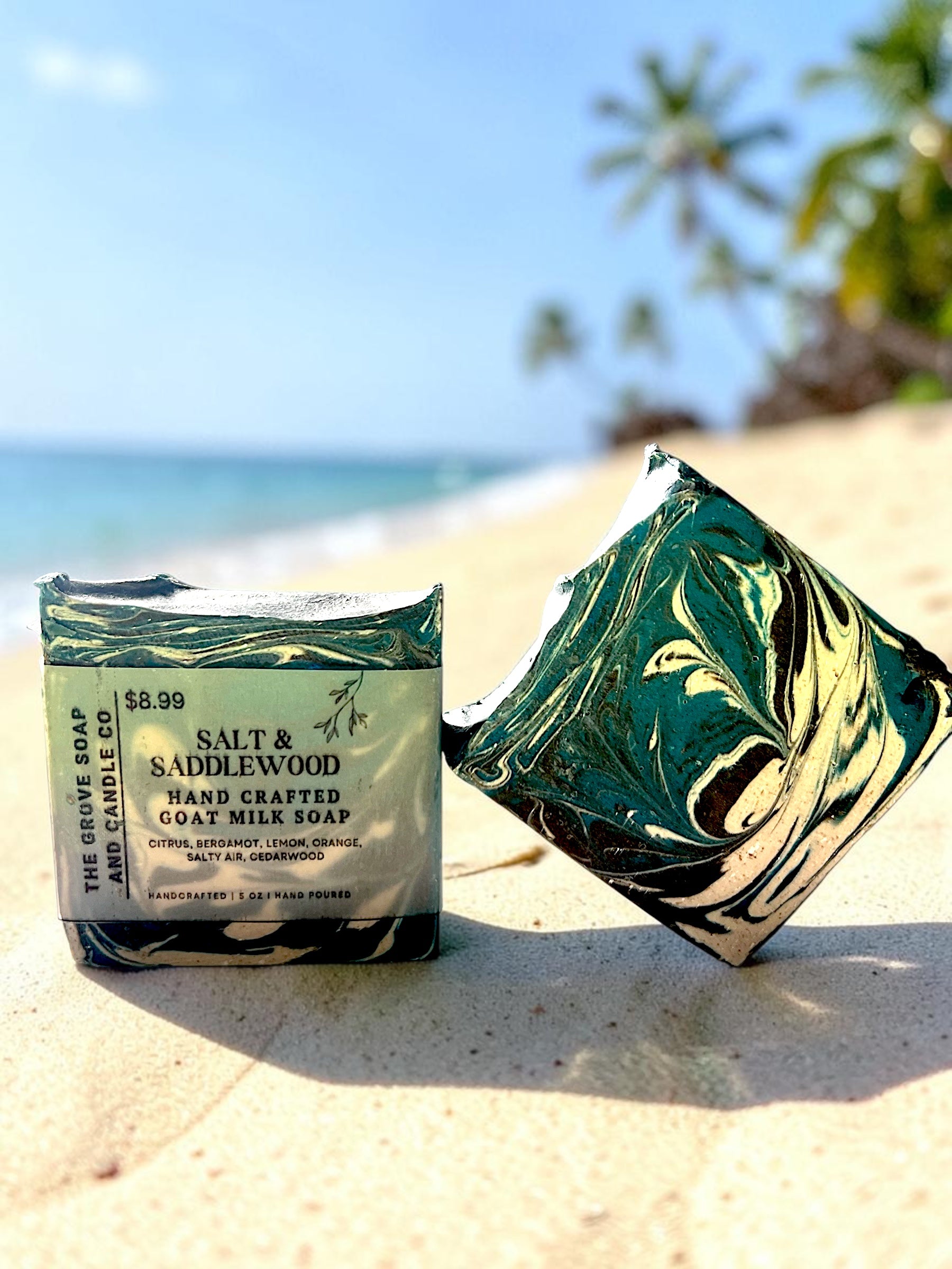Handcrafted soap bar with packaging on a sandy beach