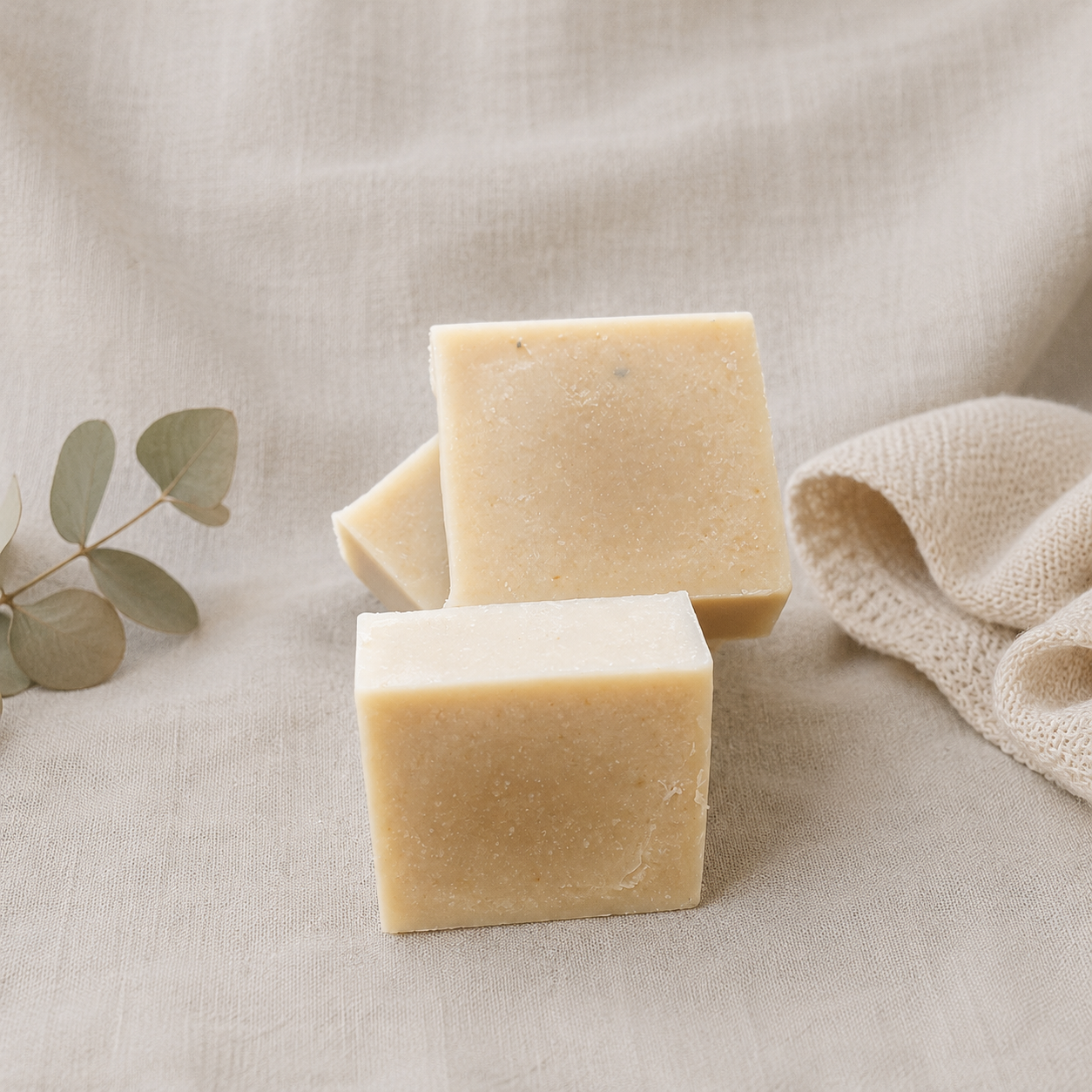 A stack of white goat milk soap bars showing no color and pure soap