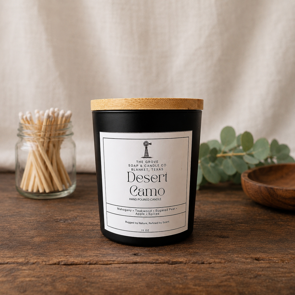 Desert Camo handpoured candle sitting on a wooden table showing the label and matte black jar.
