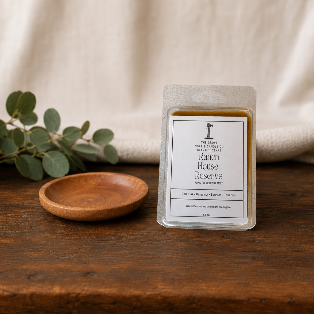 Ranch House Reserve Wax Melt sitting on a wooden table showing the label and packaging of the clamshell product