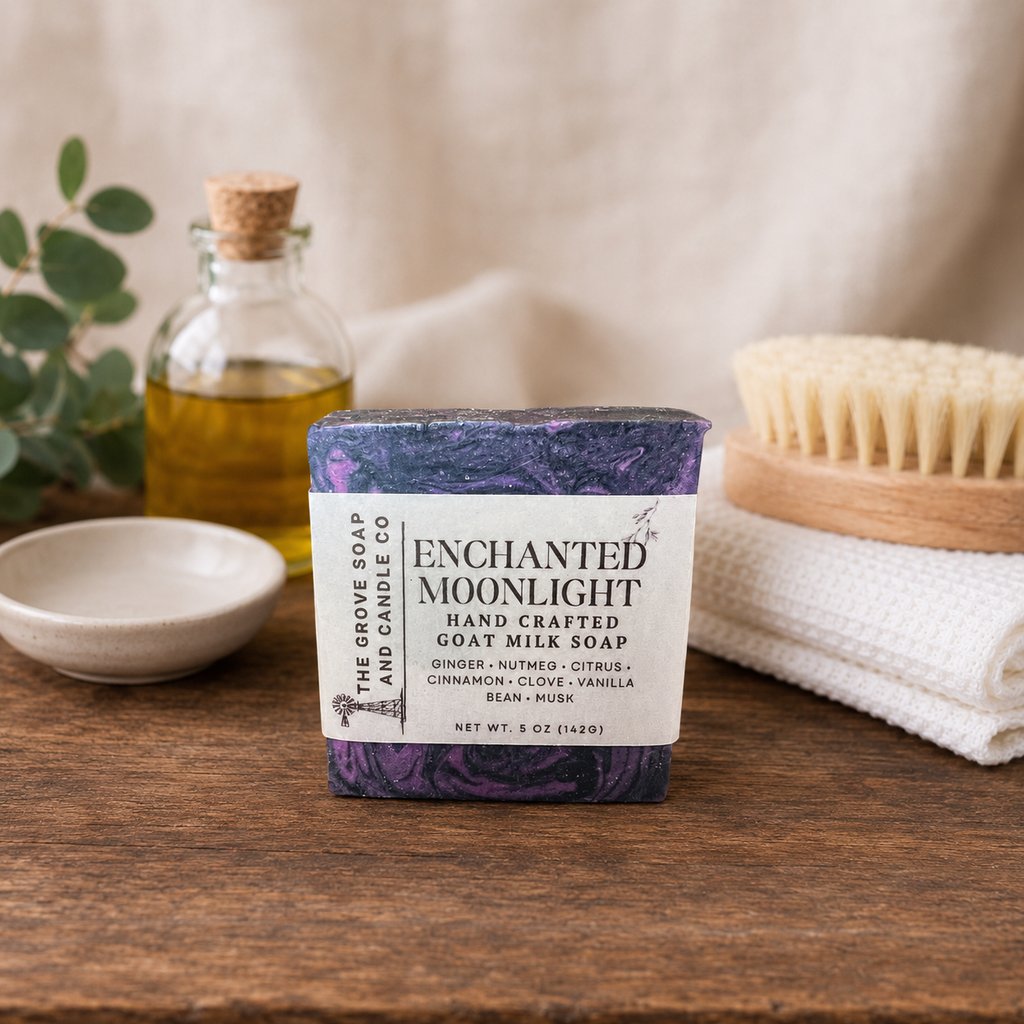 A bar of black and purple goat milk soap named Enchanted Moonlight. Shows the scent profile of ginger, nutmeg, citrus, cinnamon, clove, vanilla and musk. Sitting on a wooden table