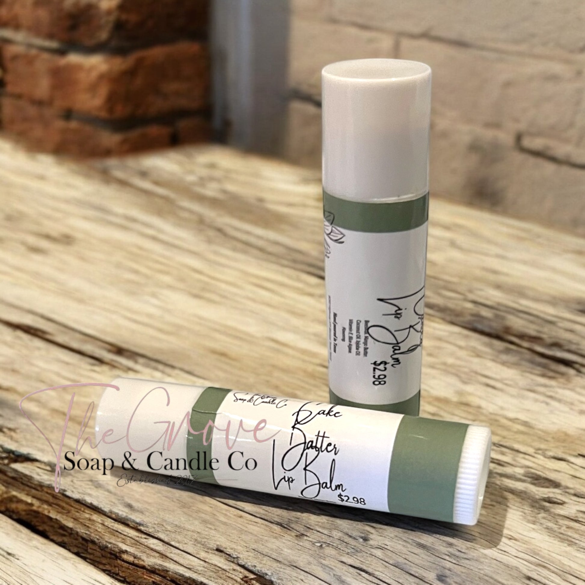 View of packaging for our natural lip balm with branding by The Grove Soap and Candle Co