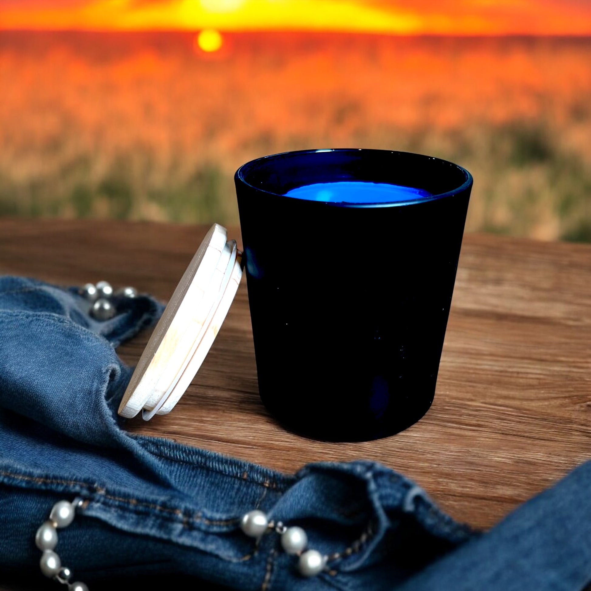 Wood wick candle with leather and strawberry scent in 14 oz matte black vessel. 11 ounces of premium coconut/paraffin wax. 
