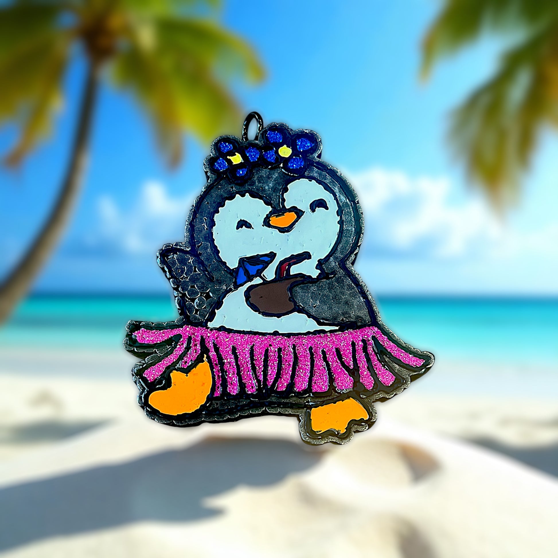 Penguin car freshie in a pink glitter hula skirt on a beach with palm trees