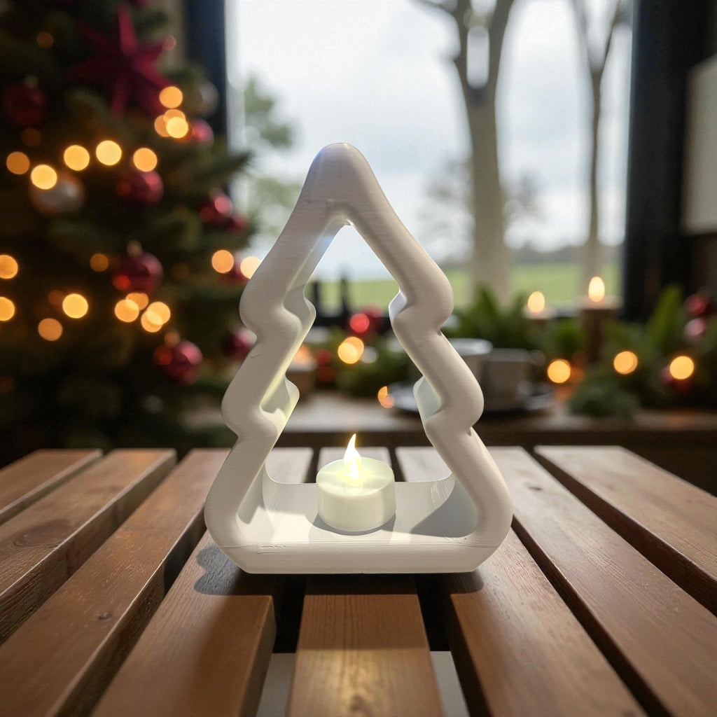 Decorative Tealight Christmas Tree in white holder on a wooden table with a festive background.