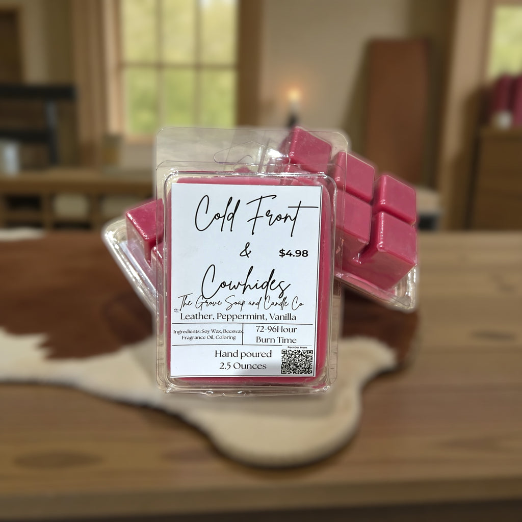 Packaged wax melts with a label of Cold front & Cowhides on a wooden surface