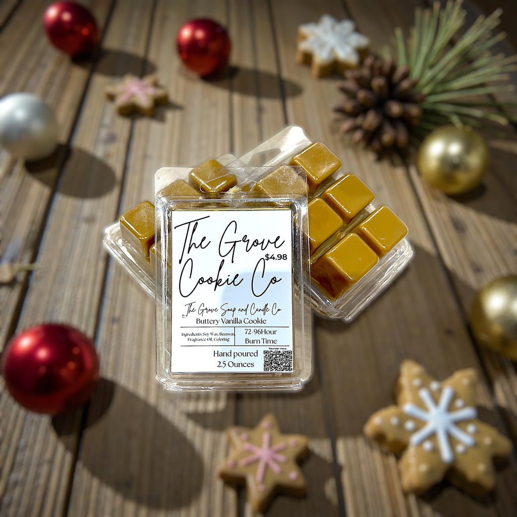 Wax melt packaging from The Grove Cookie Co on a wooden surface with Christmas decorations.
