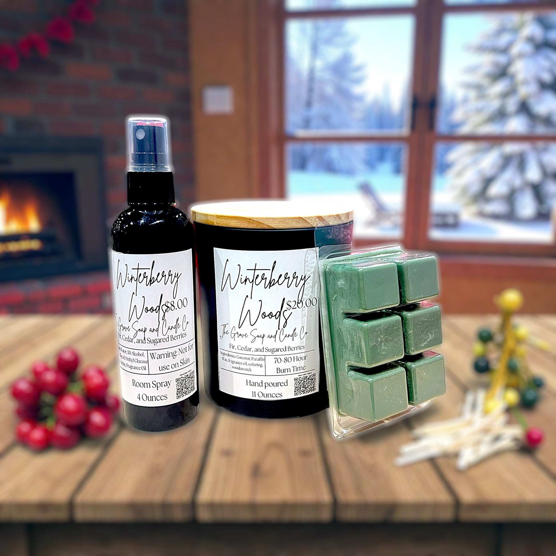 Winterberry Woods products including a room spray, candle, and wax melts on a wooden surface with a snowy outdoor scene in the background.